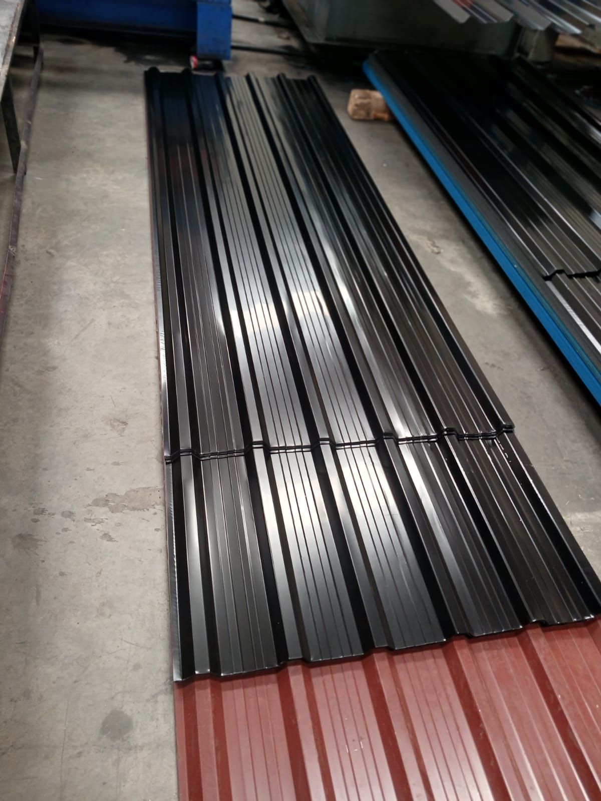 Black glossy box profile sheets stacked at the yard